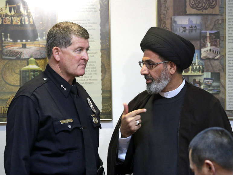 Los Angeles Police Deputy Chief Michael Downing talks with Sayed Moustafa al-Qazwini, founding Imam of the Islamic Educational Center of Orange County at a news conference in Los Angeles Monday, Nov. 28, 2016.